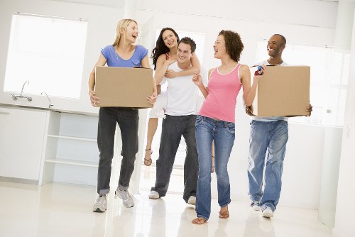 Professional house removals planning in Hackney with moving boxes and a van