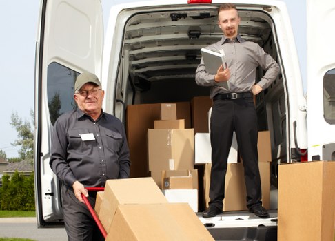 Man with a van loading furniture in Hackney street