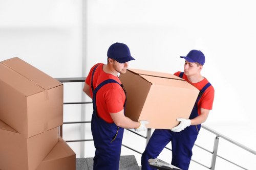 Removal van and moving team working in a Hackney street