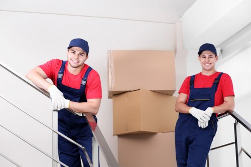 Flat removals team handling a sofa in a Hackney apartment
