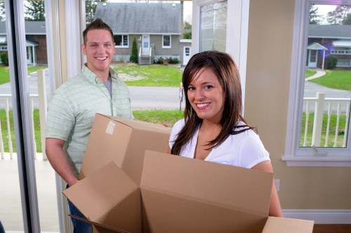 Careful packing of fragile household items into boxes