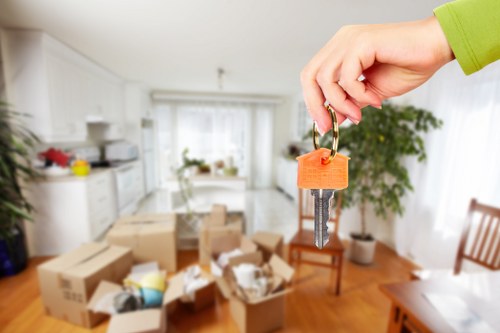 Moving team preparing a flat removal in Hackney with boxes and furniture