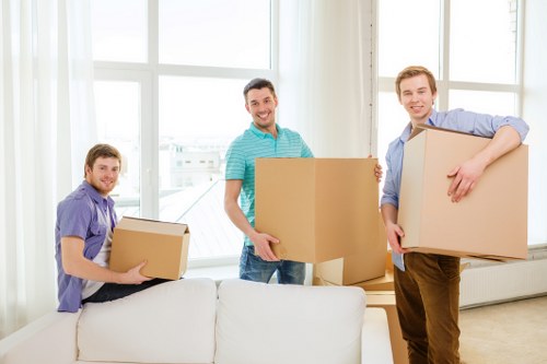 Movers packing fragile home items for a house move in Hackney